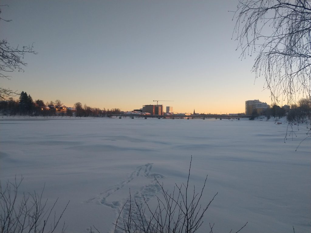 View over the frozen Umeå river and Umeå downtown