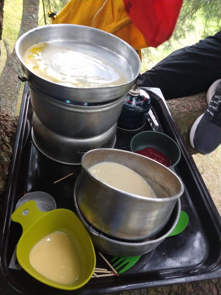 Making pancakes while sitting in a tree during one of the scout meetings